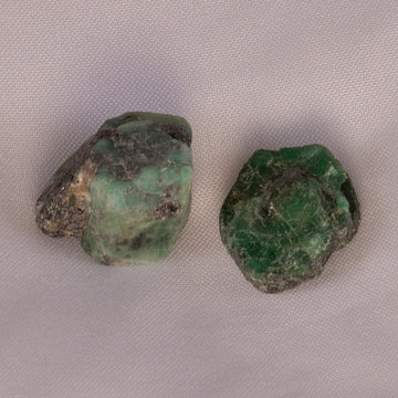 Lush green Emerald crystal, radiating soothing energy and symbolizing love, wisdom, and abundance.