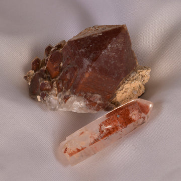 Striking Hematoid Quartz crystal, showcasing the fiery inclusions of Hematite within clear Quartz, symbolizing energy and clarity.