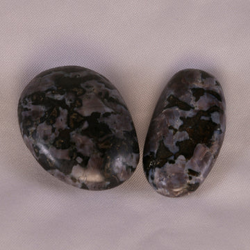 Mystic Merlinite crystal showcasing its unique dark and light mottled patterns, symbolizing the balance of yin and yang energies.