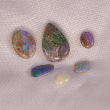 Captivating natural opal showing vibrant color play, symbolizing emotional healing and creativity.