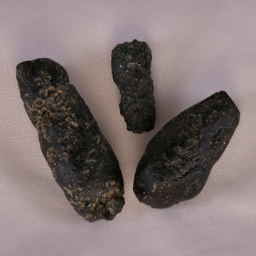 Cosmic black Tektite stone, symbolizing protection and energy amplification.