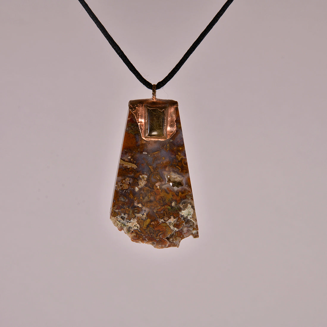 "Handcrafted copper electroformed pendant featuring a stunning combination of agate and golden rutile crystals, showcasing esoteric design and unique artisan craftsmanship."