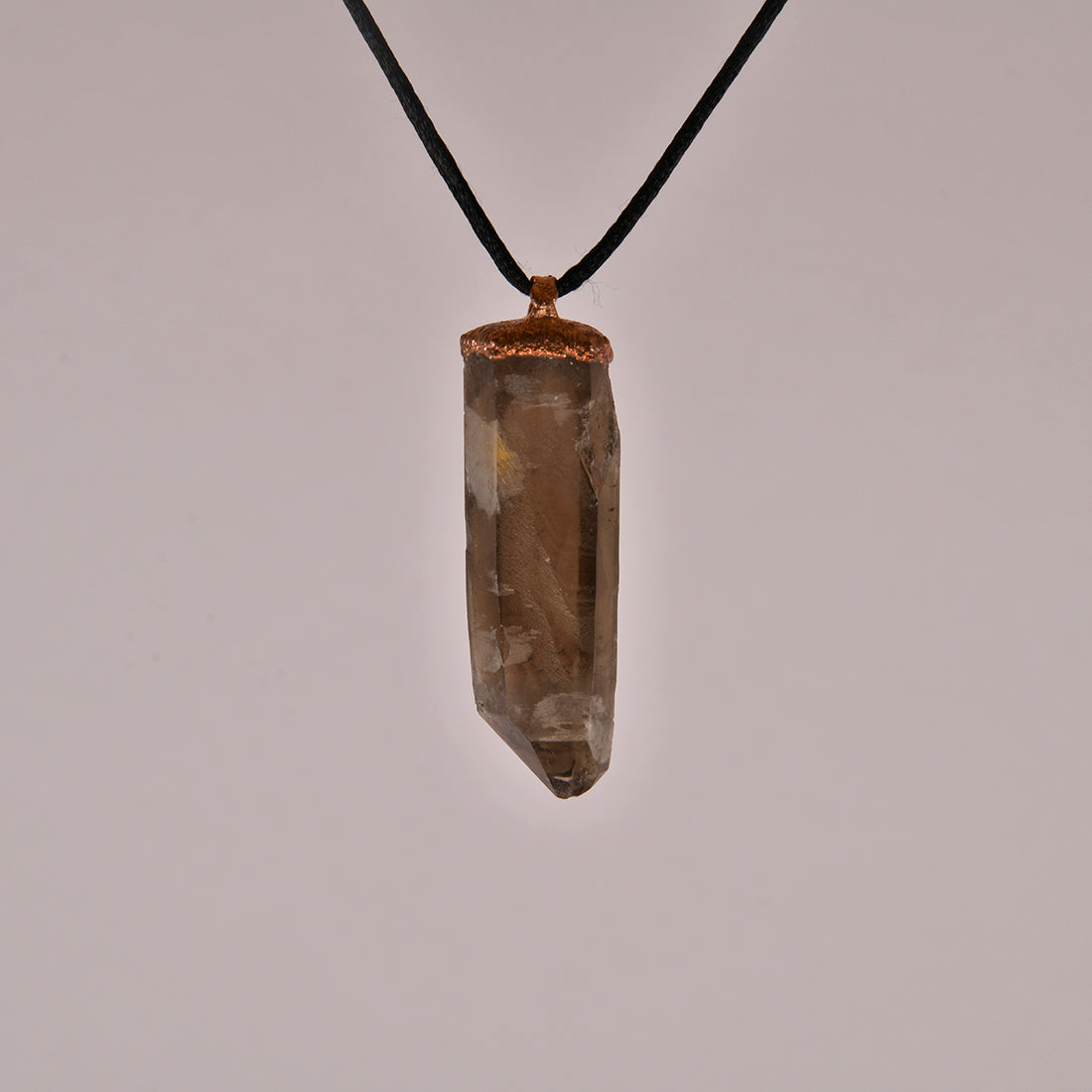 "Handcrafted copper electroformed pendant featuring a polished smoky quartz crystal, emitting grounding and protective energy. Unique esoteric jewelry piece for spiritual and healing purposes."