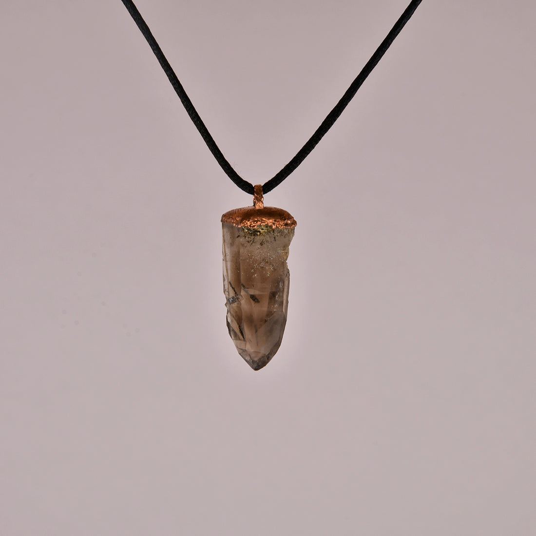 "Handcrafted copper electroformed pendant featuring a Skeletal Smoky Quartz crystal, known for its esoteric healing properties. Unique, one-of-a-kind jewellery piece for spiritual enthusiasts."