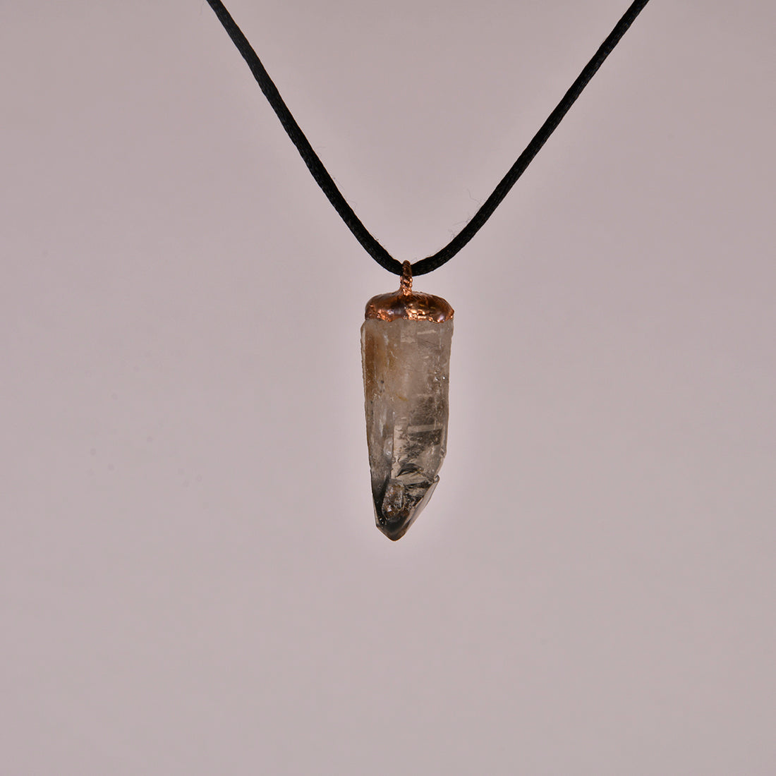 "Handcrafted copper electroformed pendant featuring a polished smoky quartz crystal, emitting grounding and protective energy. Unique esoteric jewelry piece for spiritual and healing purposes."