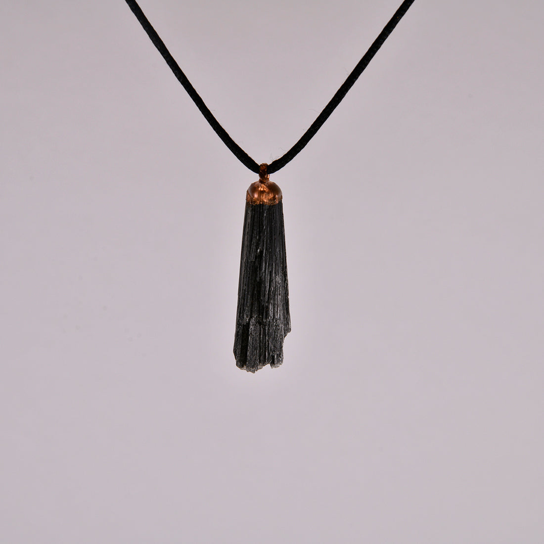 "Handcrafted black kyanite pendant, electroformed in copper, featuring esoteric crystal design for spiritual protection and grounding. Unique, artisan-made jewellery piece perfect for metaphysical enthusiasts and crystal collectors."