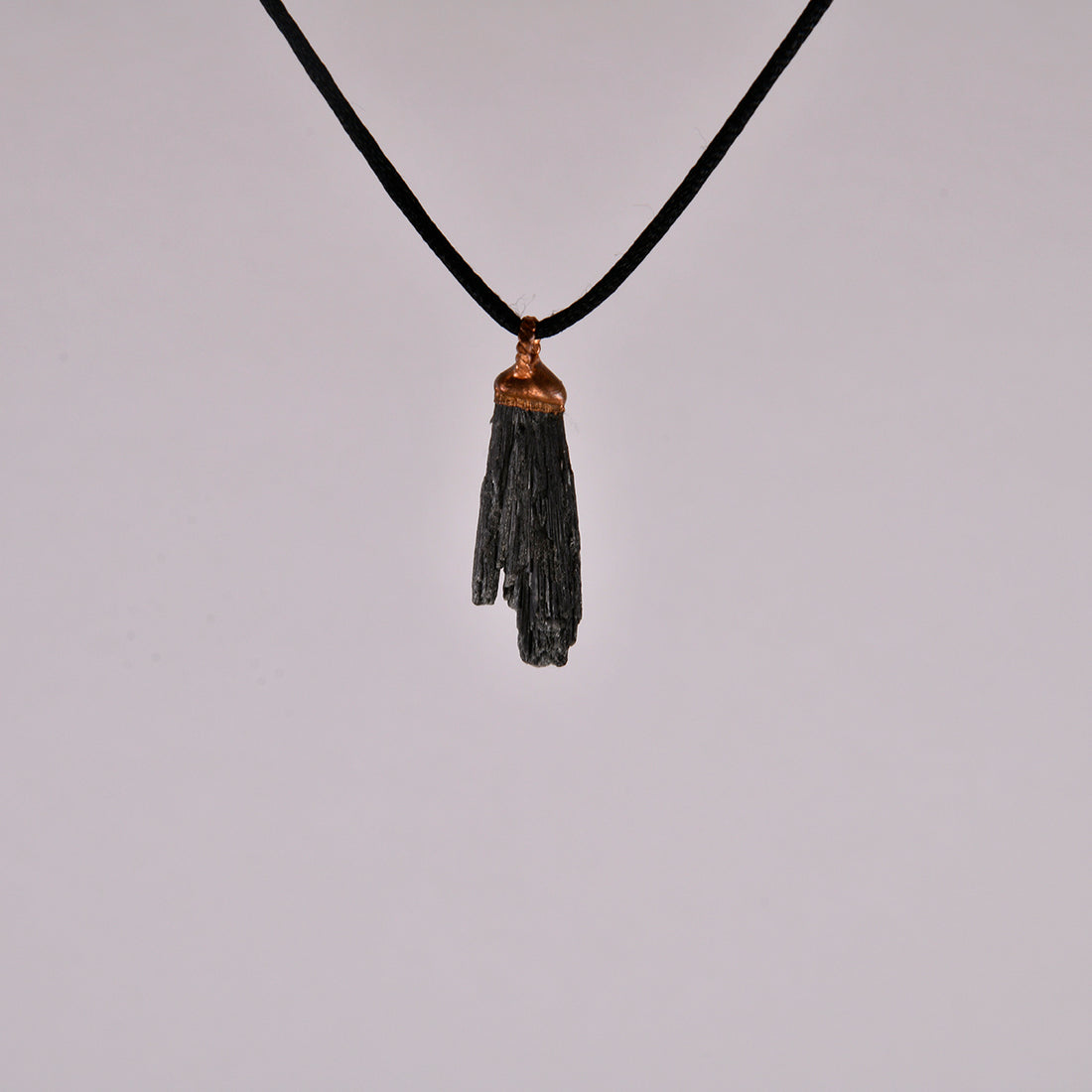 "Handcrafted black kyanite pendant, electroformed in copper, featuring esoteric crystal design for spiritual protection and grounding. Unique, artisan-made jewellery piece perfect for metaphysical enthusiasts and crystal collectors."