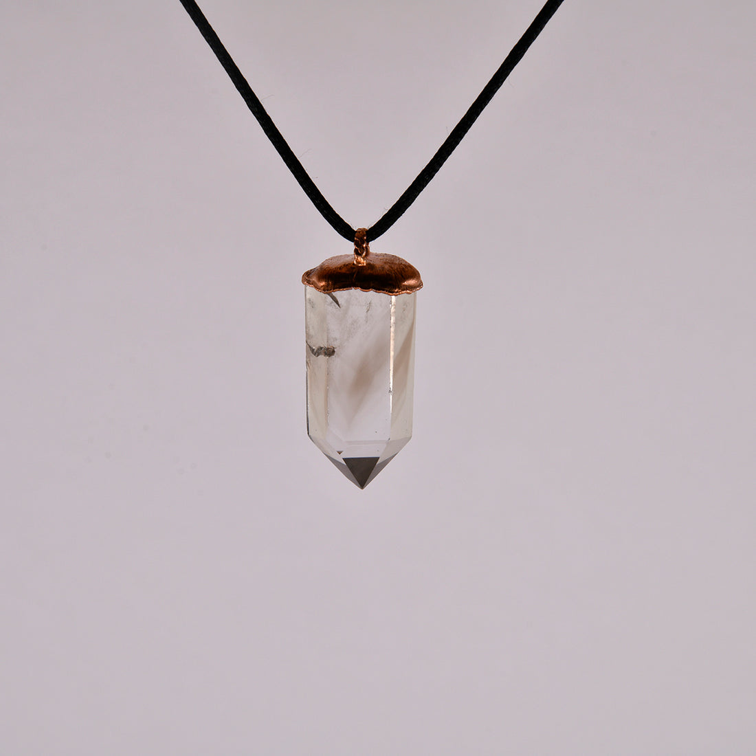 "Handcrafted copper electroformed pendant featuring a polished smoky quartz crystal, emitting grounding and protective energy. Unique esoteric jewelry piece for spiritual and healing purposes."