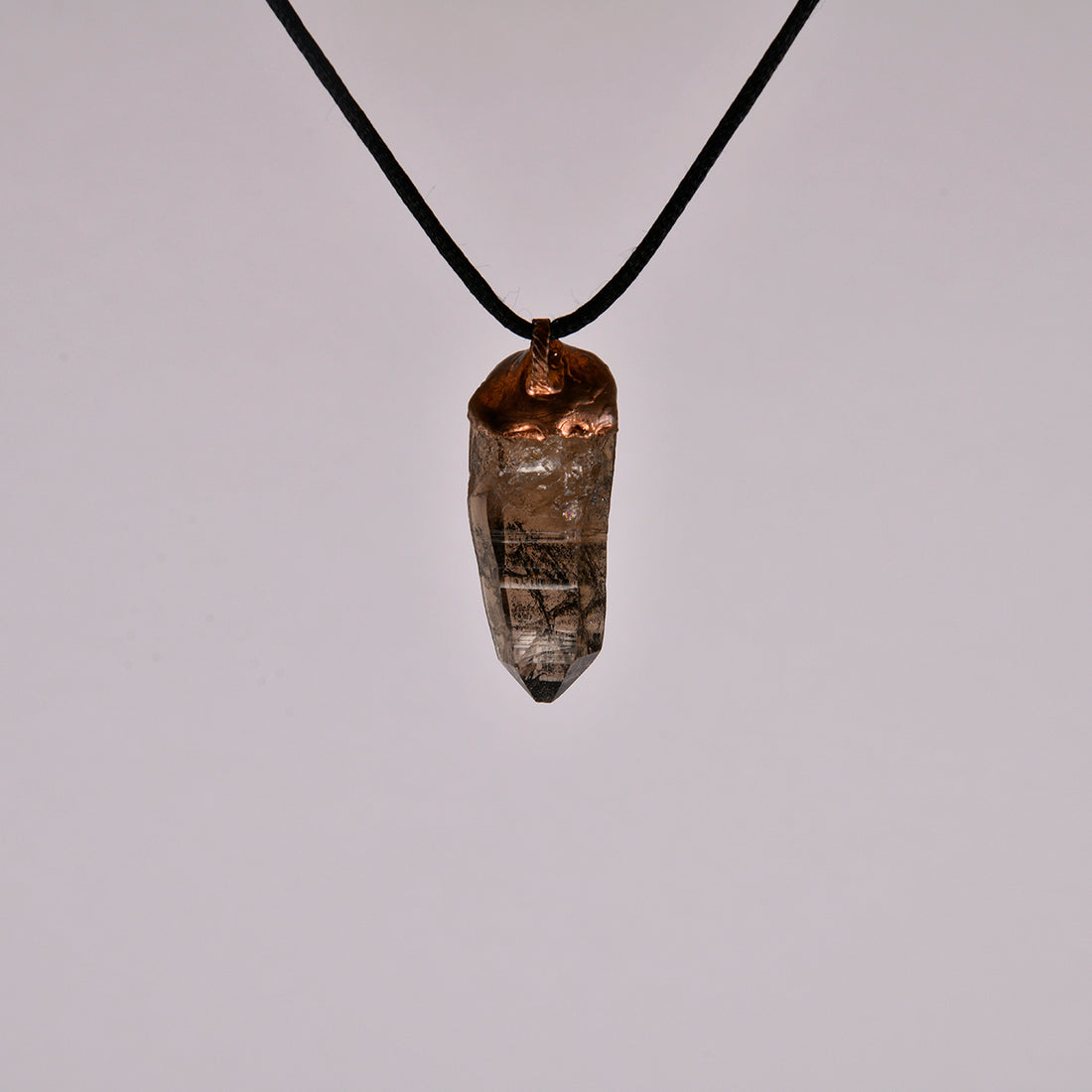 "Handcrafted copper electroformed pendant featuring a polished smoky quartz crystal, emitting grounding and protective energy. Unique esoteric jewelry piece for spiritual and healing purposes."