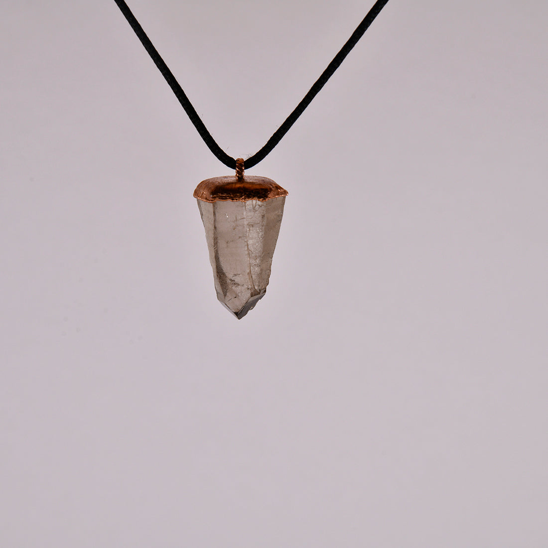 "Handcrafted copper electroformed pendant featuring a polished smoky quartz crystal, emitting grounding and protective energy. Unique esoteric jewelry piece for spiritual and healing purposes."