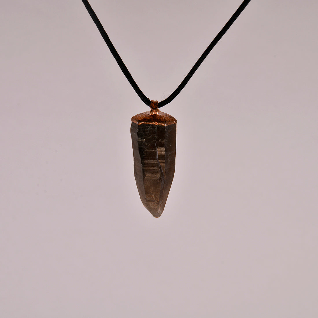 "Handcrafted copper electroformed pendant featuring a Lemurian Skeletal Smoky Quartz crystal, perfect for esoteric crystal jewelry lovers. Unique and mystical, this pendant showcases the natural beauty and energy of Lemurian quartz."