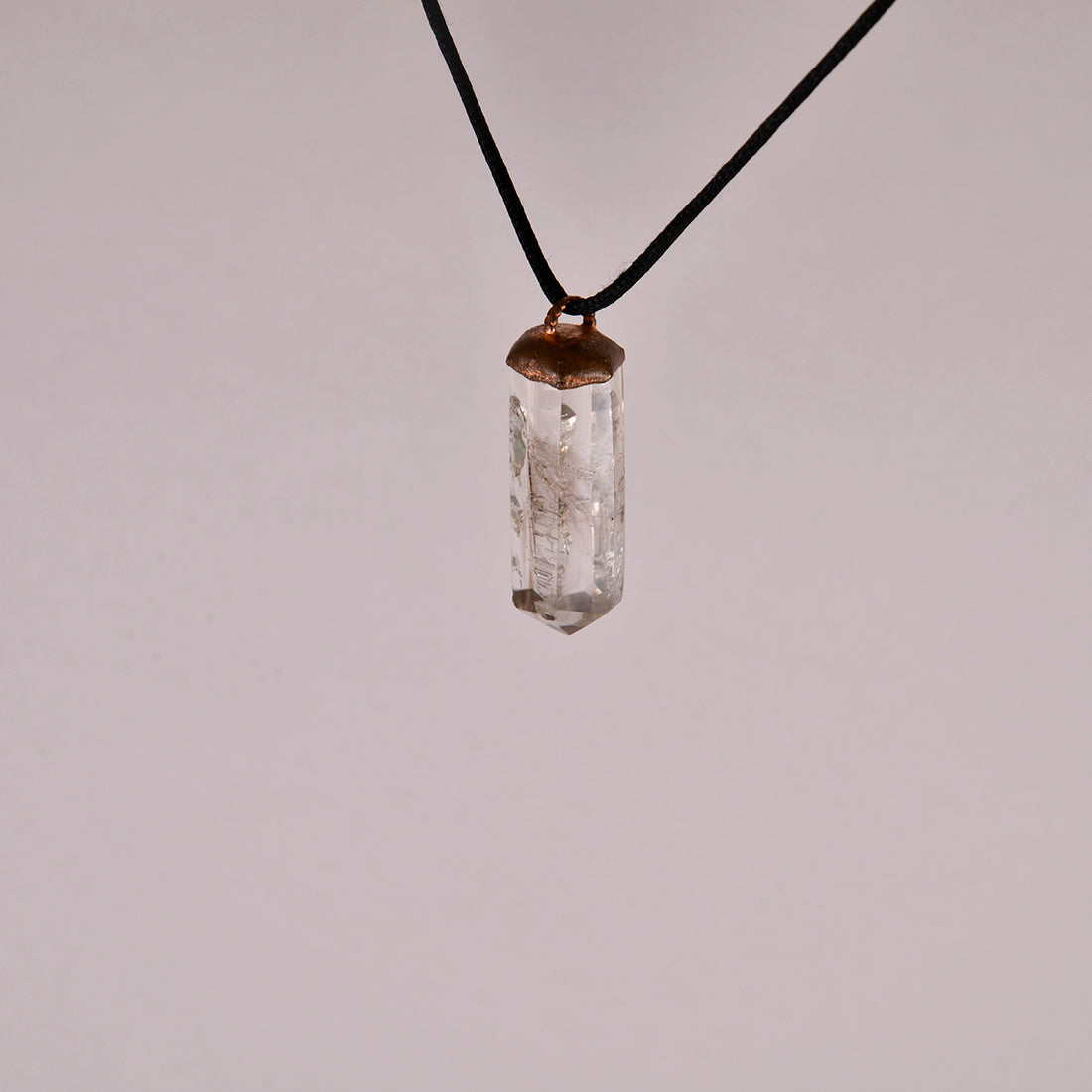 "Handcrafted copper electroformed pendant featuring a stunning Smoky Phantom Quartz crystal, perfect for adding a touch of esoteric elegance to your style."