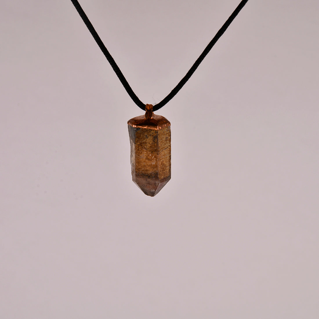 "Handcrafted copper electroformed pendant featuring a stunning Smoky Phantom Quartz crystal, perfect for adding a touch of esoteric elegance to your style."