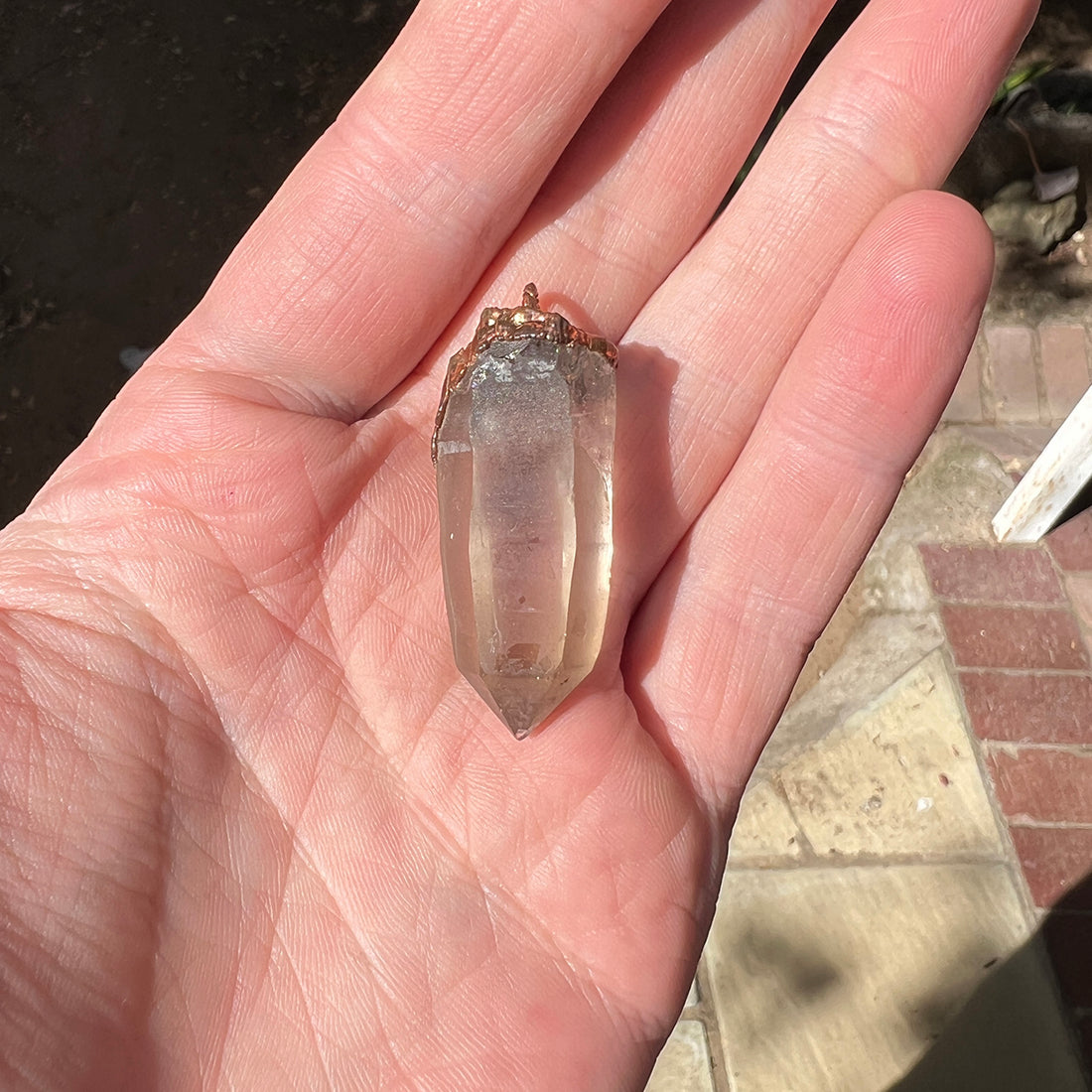 "Handcrafted copper electroformed pendant featuring a polished smoky quartz crystal, emitting grounding and protective energy. Unique esoteric jewelry piece for spiritual and healing purposes."