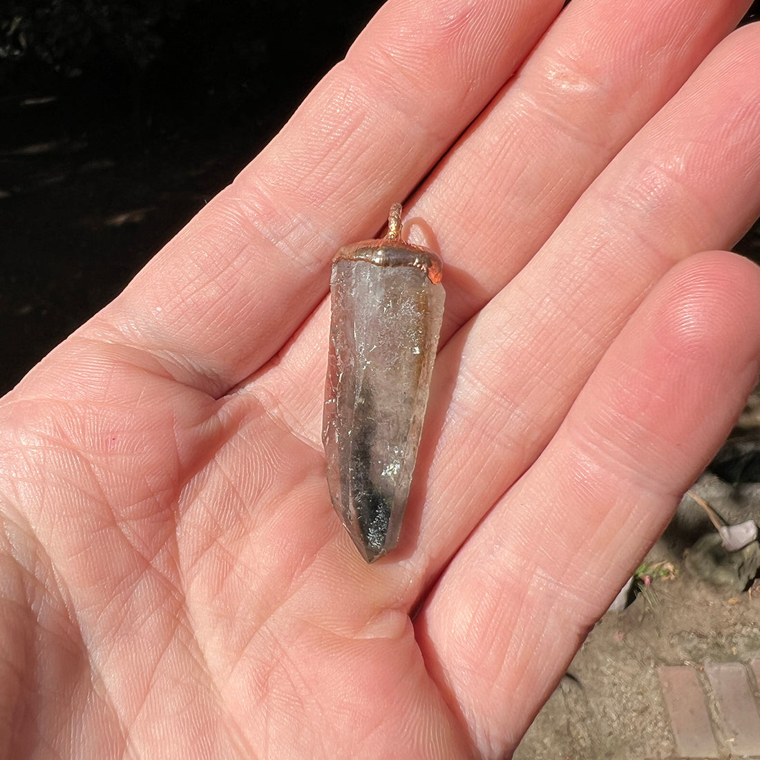 "Handcrafted copper electroformed pendant featuring a polished smoky quartz crystal, emitting grounding and protective energy. Unique esoteric jewelry piece for spiritual and healing purposes."