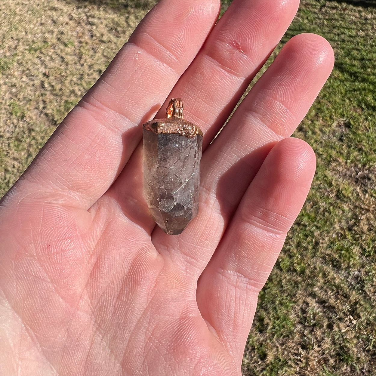 "Handcrafted copper electroformed pendant featuring a Skeletal Smoky Quartz crystal, known for its esoteric healing properties. Unique, one-of-a-kind jewellery piece for spiritual enthusiasts."