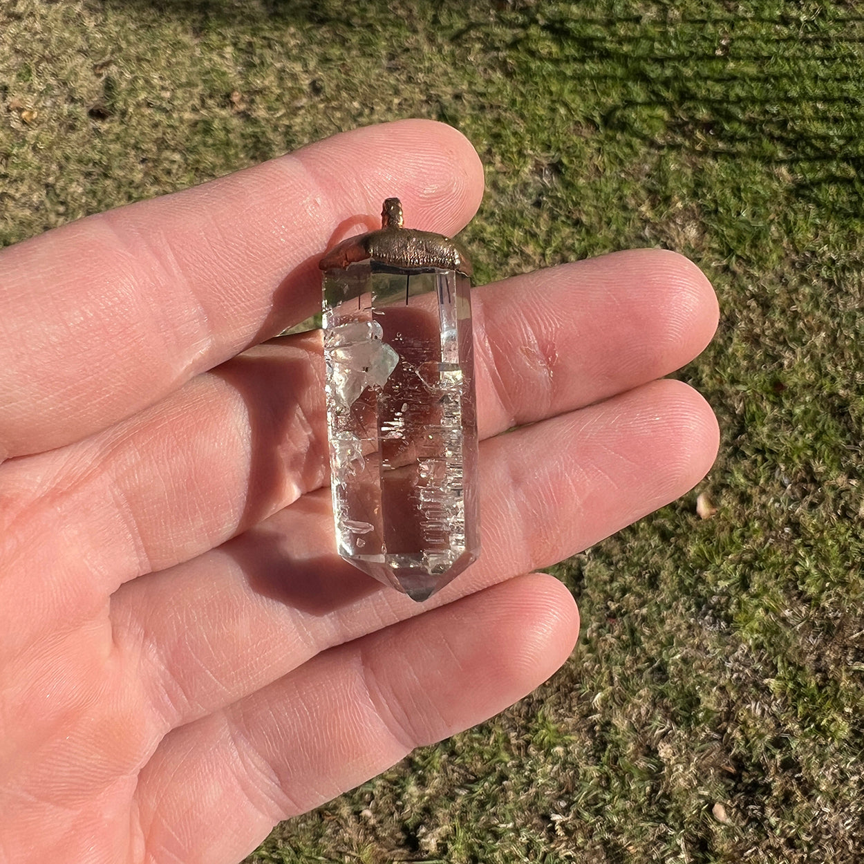 "Handcrafted copper electroformed pendant featuring a stunning Smoky Phantom Quartz crystal, perfect for adding a touch of esoteric elegance to your style."