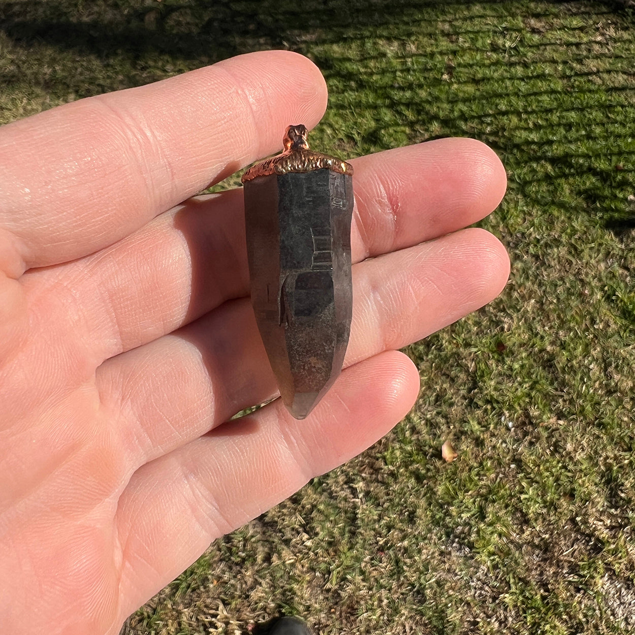 "Handcrafted copper electroformed pendant featuring a Lemurian Skeletal Smoky Quartz crystal, perfect for esoteric crystal jewelry lovers. Unique and mystical, this pendant showcases the natural beauty and energy of Lemurian quartz."