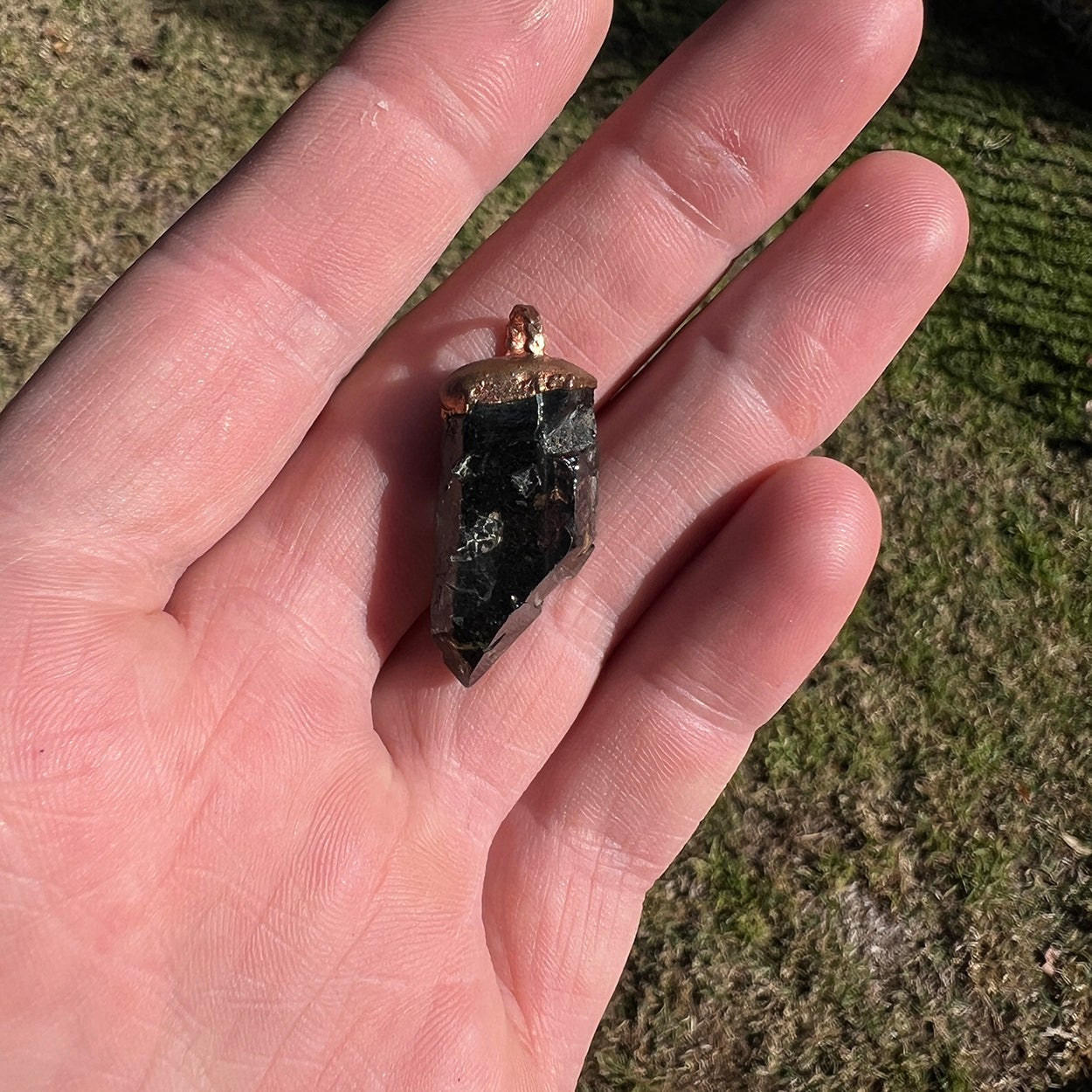 "Handcrafted copper electroformed pendant featuring a Skeletal Smoky Quartz crystal, known for its esoteric healing properties. Unique, one-of-a-kind jewellery piece for spiritual enthusiasts."