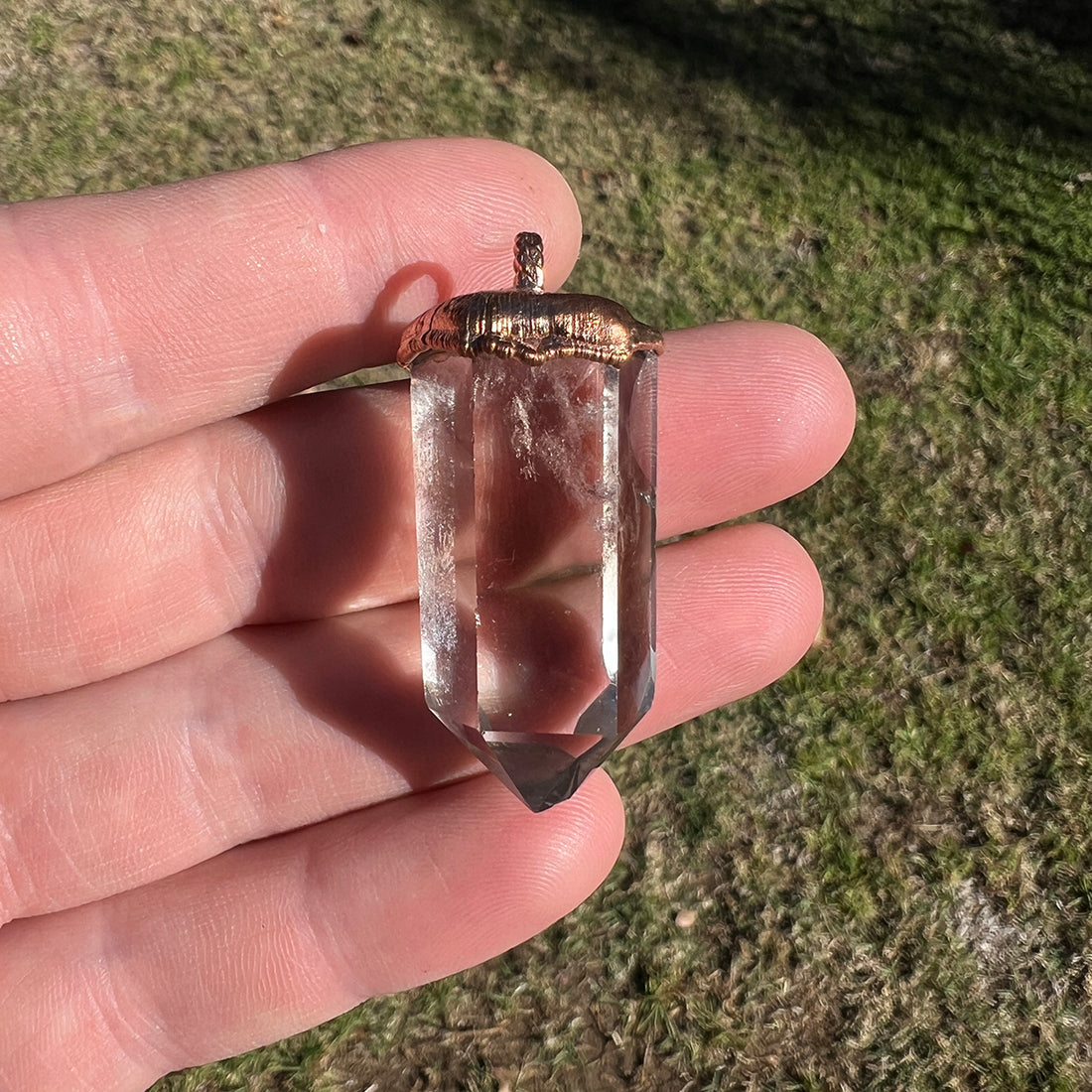 "Handcrafted copper electroformed pendant featuring a polished smoky quartz crystal, emitting grounding and protective energy. Unique esoteric jewelry piece for spiritual and healing purposes."