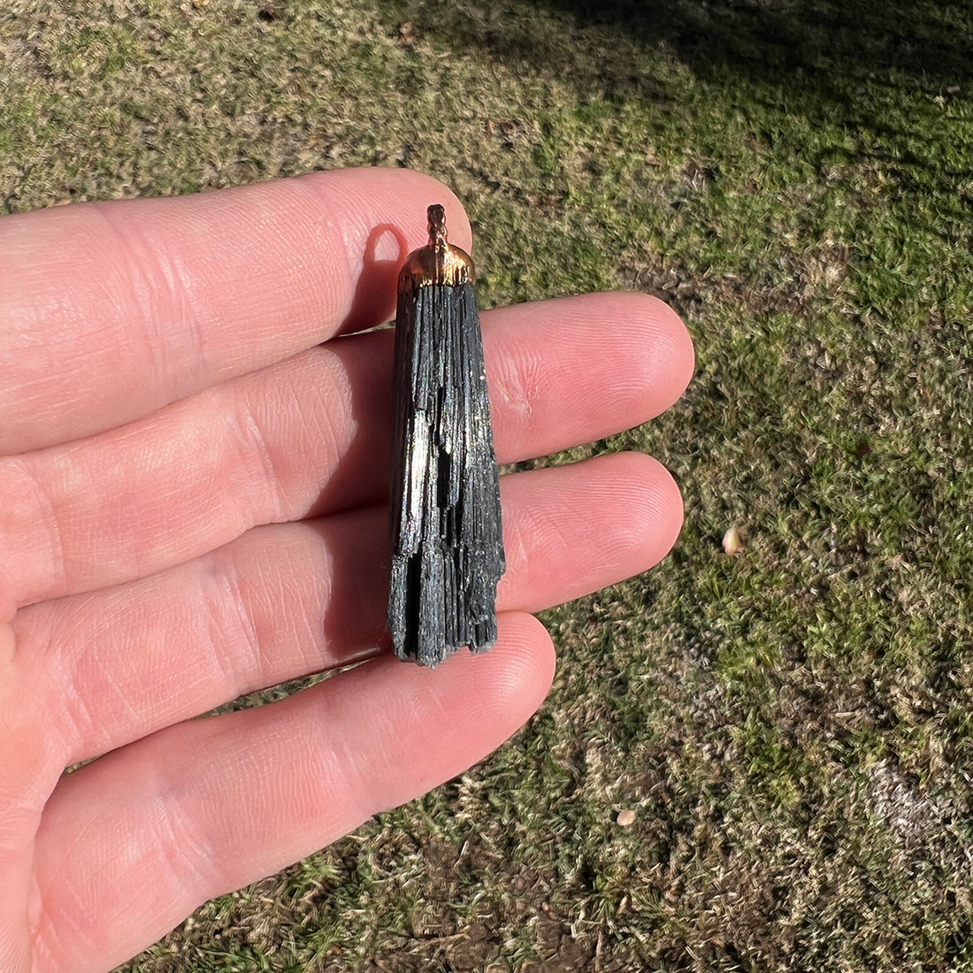 "Handcrafted black kyanite pendant, electroformed in copper, featuring esoteric crystal design for spiritual protection and grounding. Unique, artisan-made jewellery piece perfect for metaphysical enthusiasts and crystal collectors."