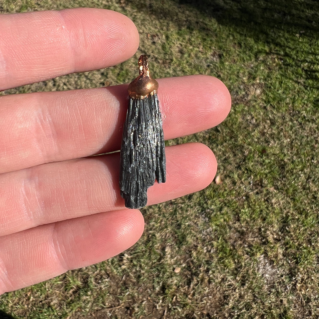 "Handcrafted black kyanite pendant, electroformed in copper, featuring esoteric crystal design for spiritual protection and grounding. Unique, artisan-made jewellery piece perfect for metaphysical enthusiasts and crystal collectors."