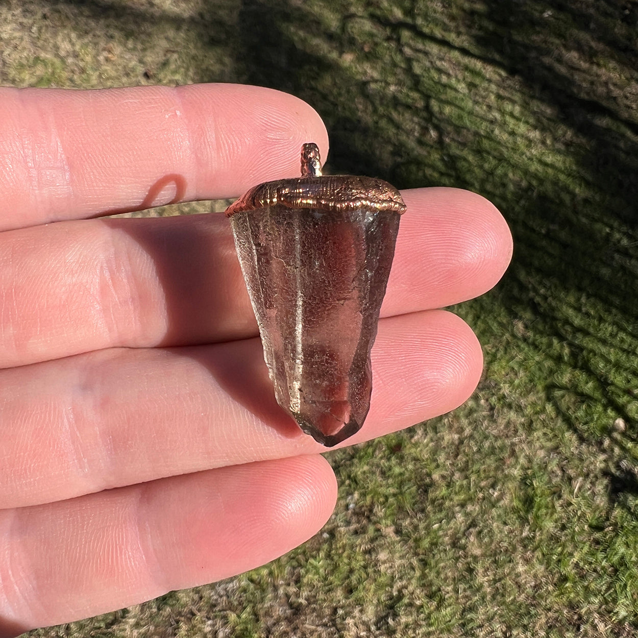 "Handcrafted copper electroformed pendant featuring a polished smoky quartz crystal, emitting grounding and protective energy. Unique esoteric jewelry piece for spiritual and healing purposes."