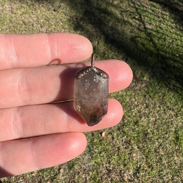 "Handcrafted copper electroformed pendant featuring a polished smoky quartz crystal, emitting grounding and protective energy. Unique esoteric jewelry piece for spiritual and healing purposes."