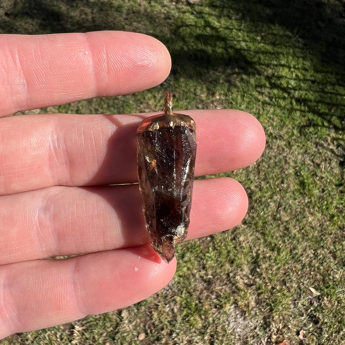 "Handcrafted copper electroformed pendant featuring a polished smoky quartz crystal, emitting grounding and protective energy. Unique esoteric jewelry piece for spiritual and healing purposes."