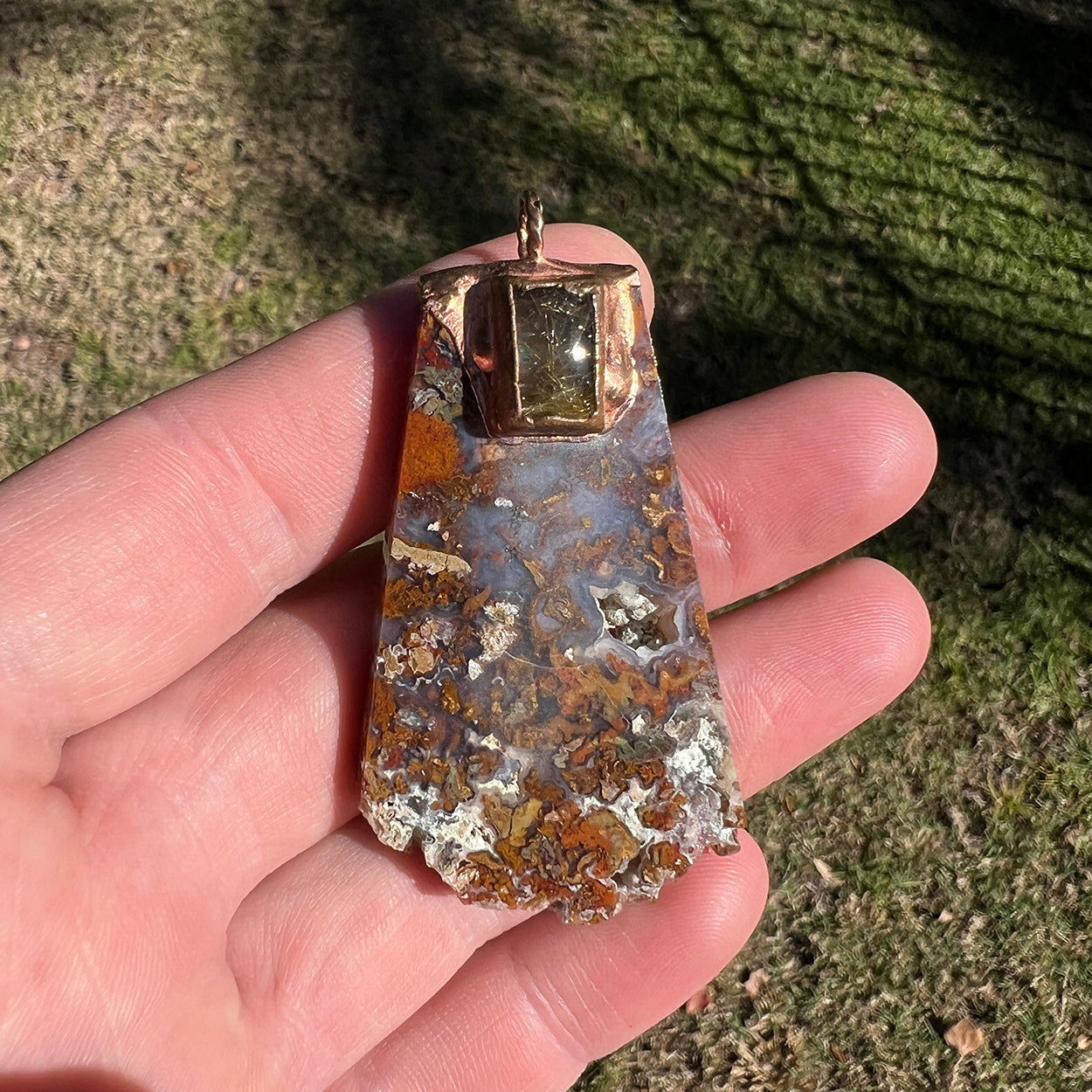 "Handcrafted copper electroformed pendant featuring a stunning combination of agate and golden rutile crystals, showcasing esoteric design and unique artisan craftsmanship."